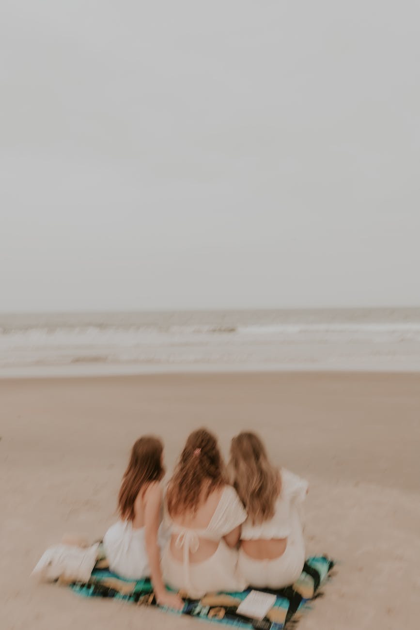 women sitting on beach