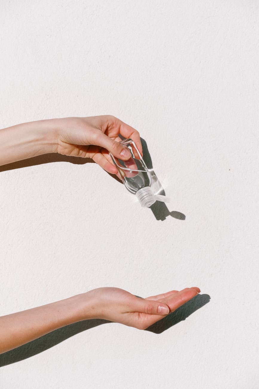 person holding hand sanitizer