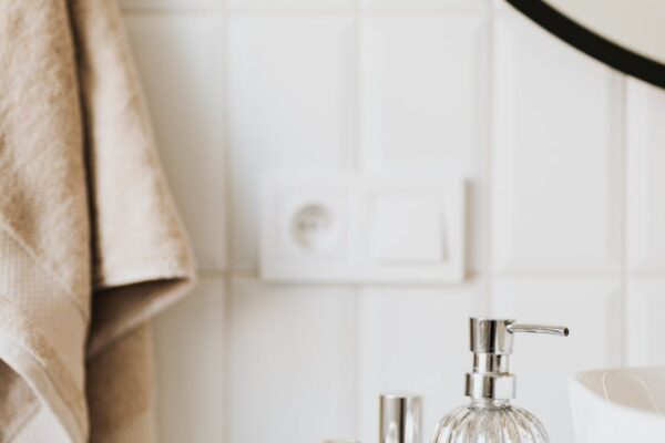 set of skincare supplies on white table in bathroom