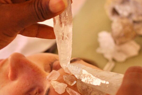 crop ethnic master transferring crystal energy to female client