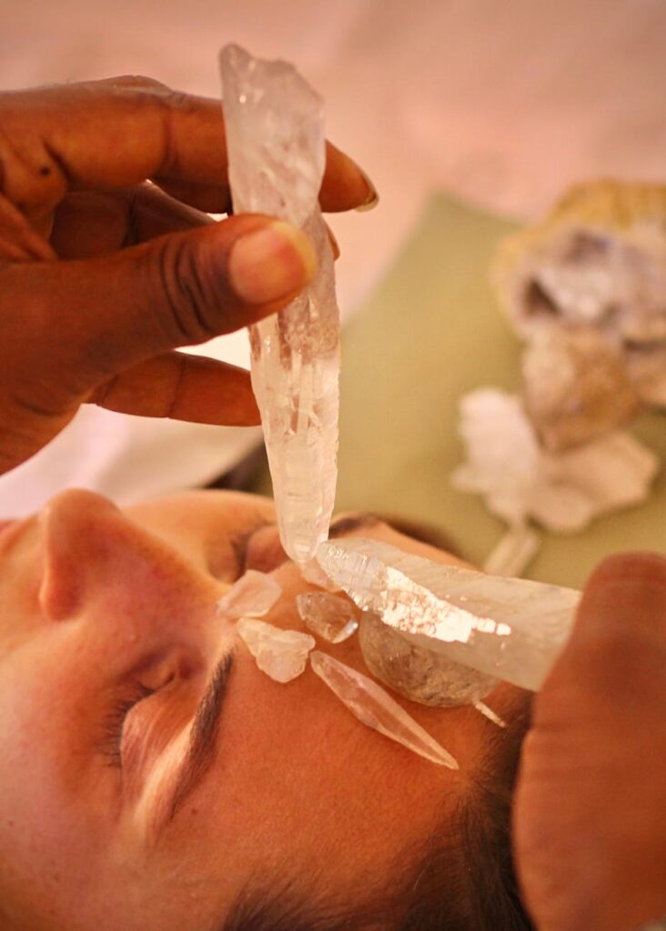 crop ethnic master transferring crystal energy to female client