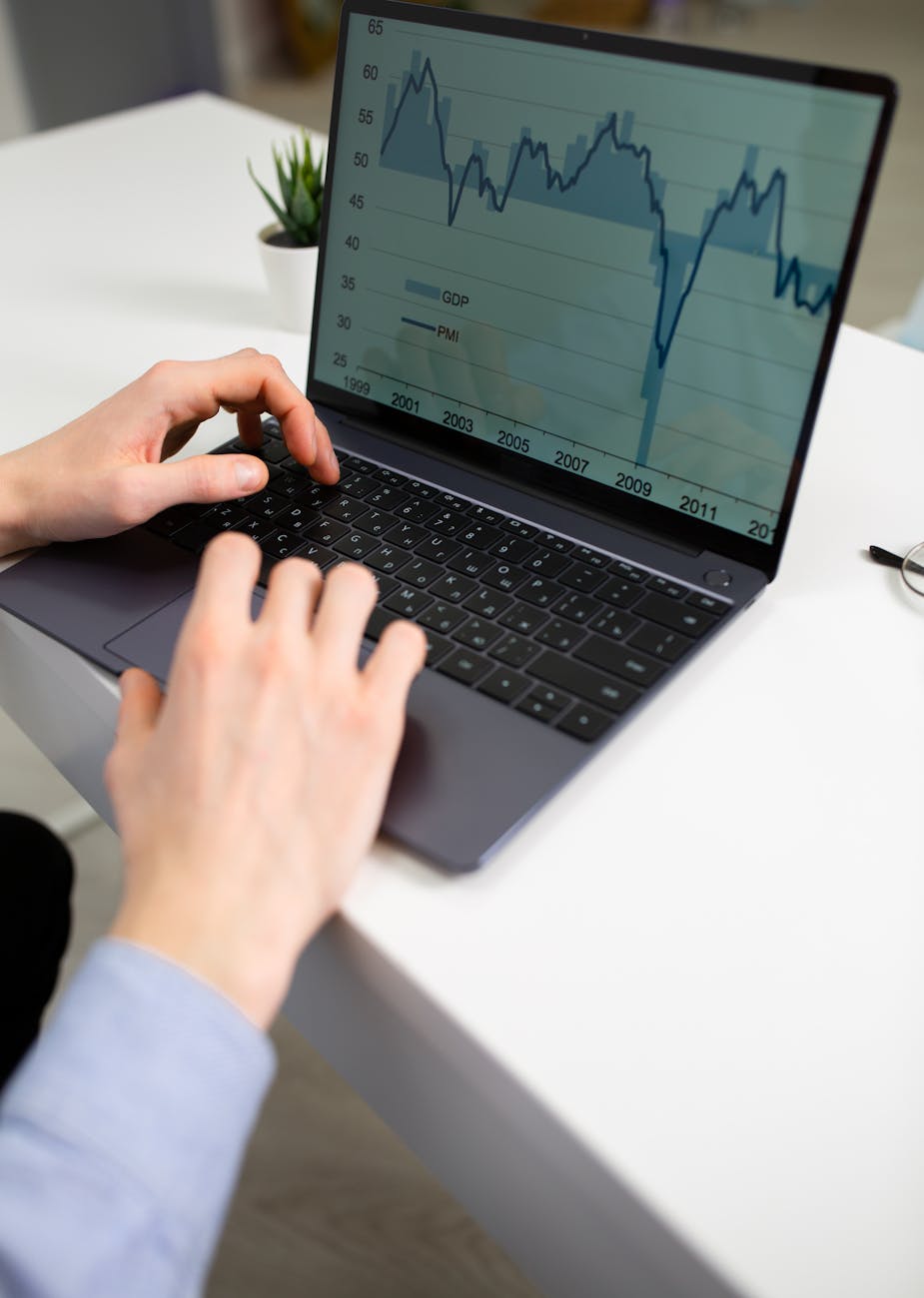 anonymous businessman working on financial project using laptop in office