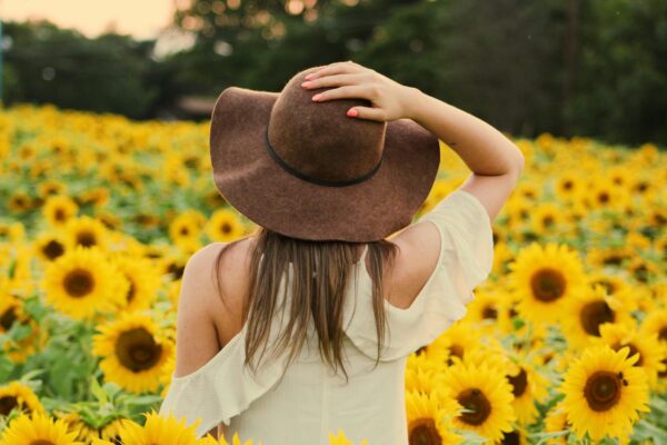 photo of woman in a sunflower field